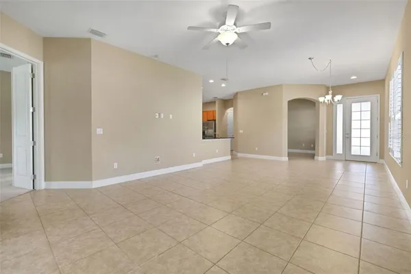 a view of an empty room and a ceiling fan