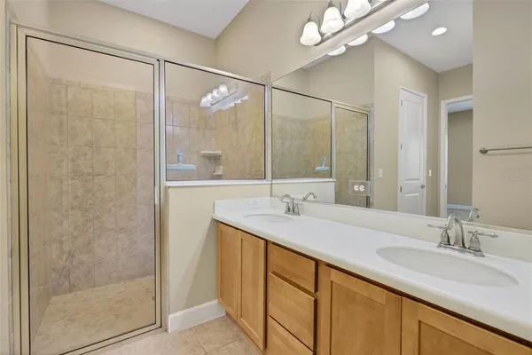 a bathroom with a shower sink and mirror