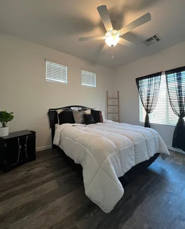 a bedroom with a bed and window
