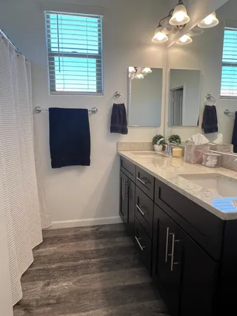 a bathroom with a double vanity sink and mirror