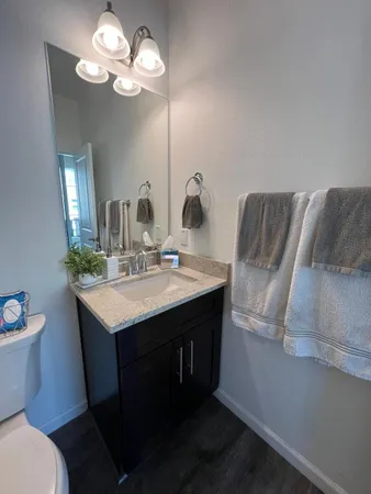 a bathroom with a sink a toilet and a mirror