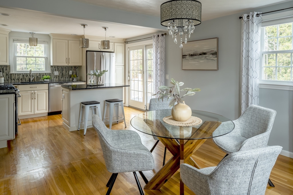 1 Roberts Road Billerica, MA 01821 - Photo 3 of 16 a kitchen with stainless steel appliances kitchen island granite countertop a table and chairs