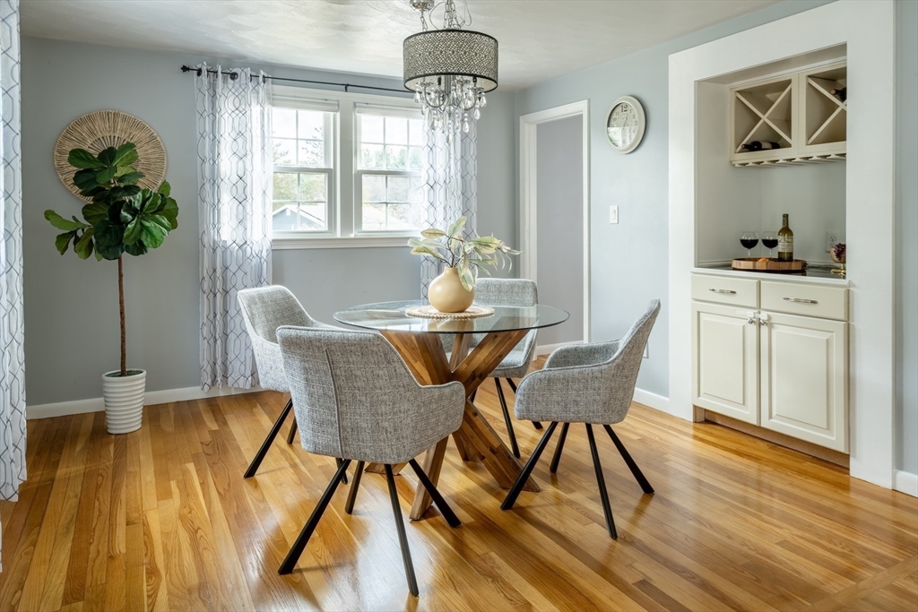 1 Roberts Road Billerica, MA 01821 - Photo 4 of 16 a dining room with furniture potted plants and wooden floor