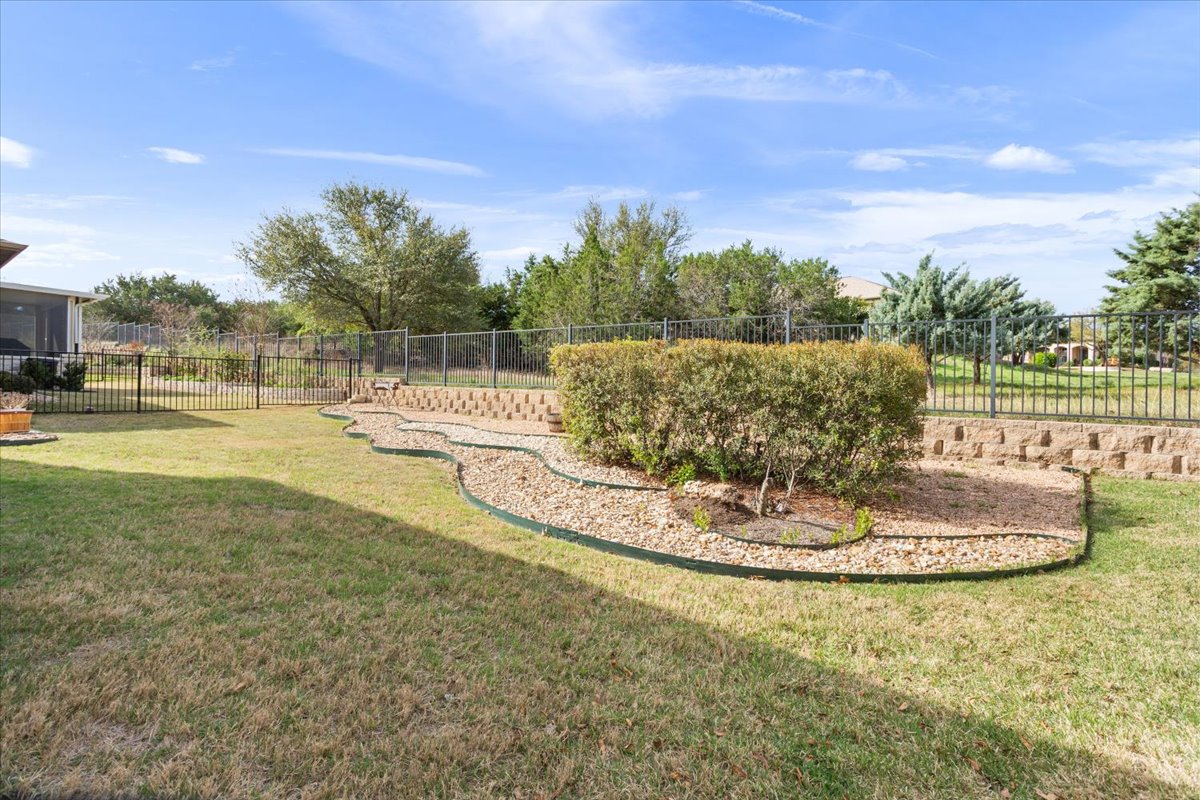 108 Cathedral Mountain Pass Georgetown, TX 78633 - Photo 34 of 36 a swimming pool with trees in the background