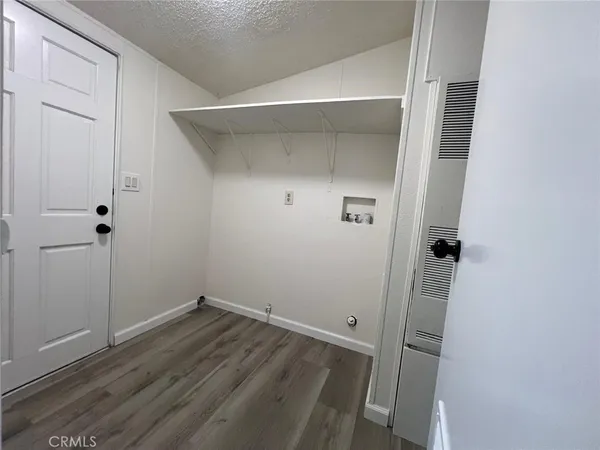 a view of a room with wooden floor and closet