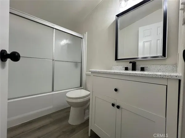 a bathroom with a sink toilet and mirror