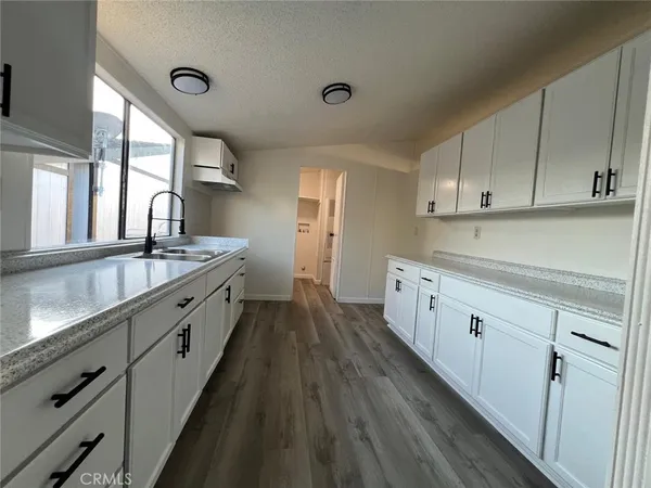 a kitchen with cabinets a sink and appliances