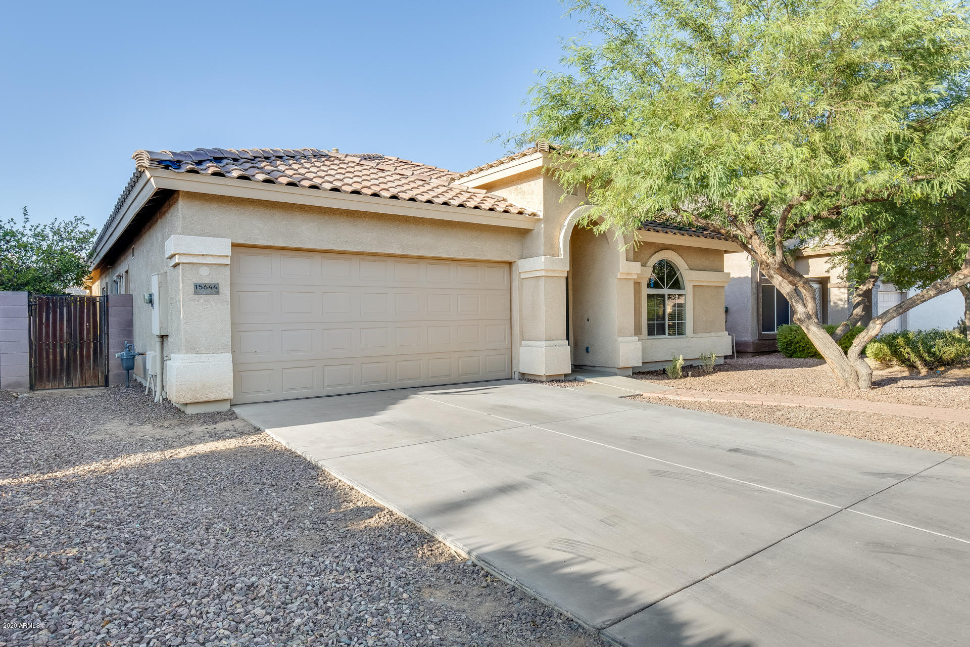 15644 West Calavar Road Surprise, AZ 85379 - Photo 6 of 34 a front view of a house with a garage