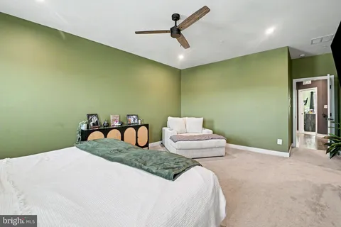 a bedroom with a bed and ceiling fan