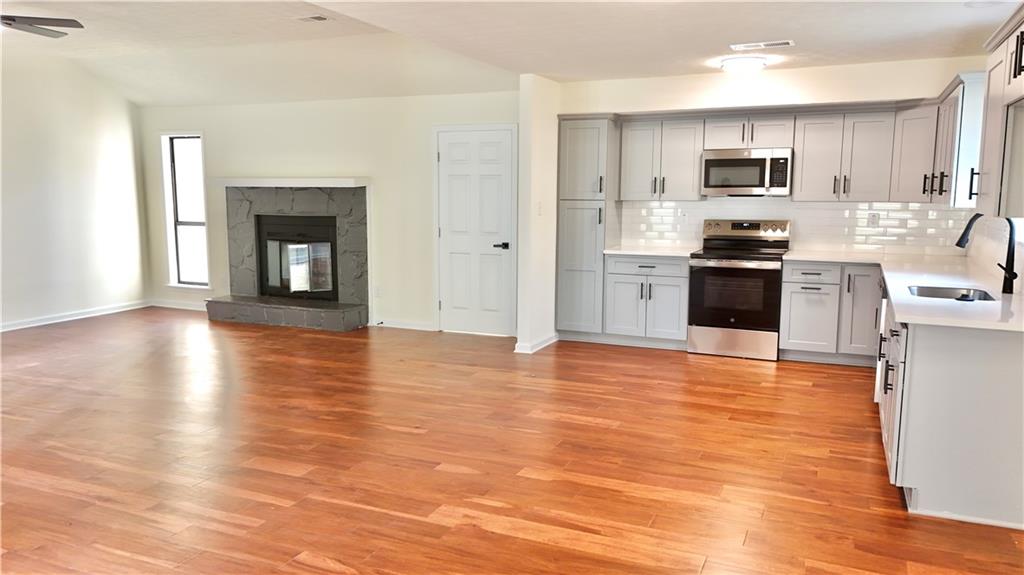 5257 Post Ridge Court Stone Mountain, GA 30088 - Photo 14 of 42 a view of kitchen with granite countertop stainless steel appliances and wooden floor