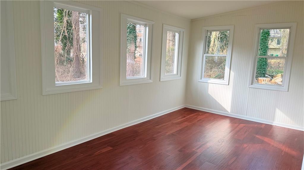 5257 Post Ridge Court Stone Mountain, GA 30088 - Photo 17 of 42 a view of an empty room with wooden floor and a window