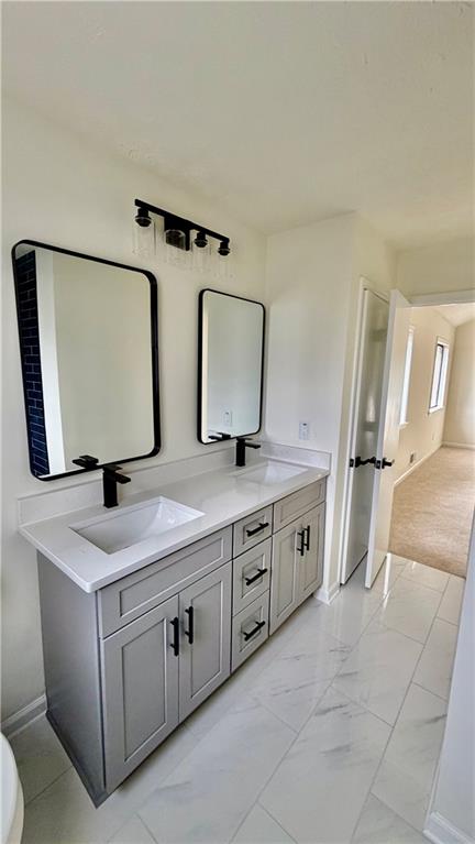 5257 Post Ridge Court Stone Mountain, GA 30088 - Photo 24 of 42 a bathroom with double sink and a mirror