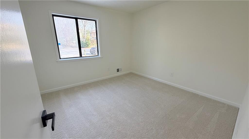 5257 Post Ridge Court Stone Mountain, GA 30088 - Photo 29 of 42 an empty room with a window