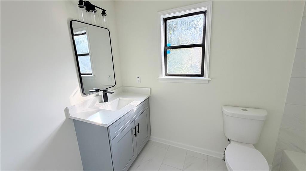 5257 Post Ridge Court Stone Mountain, GA 30088 - Photo 31 of 42 a bathroom with a toilet sink and mirror