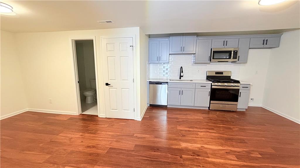 5257 Post Ridge Court Stone Mountain, GA 30088 - Photo 34 of 42 a kitchen with granite countertop a stove and a refrigerator