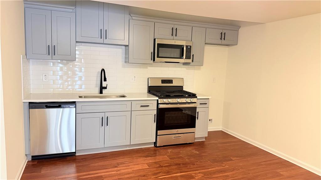 5257 Post Ridge Court Stone Mountain, GA 30088 - Photo 35 of 42 a kitchen with stainless steel appliances a sink dishwasher stove and microwave