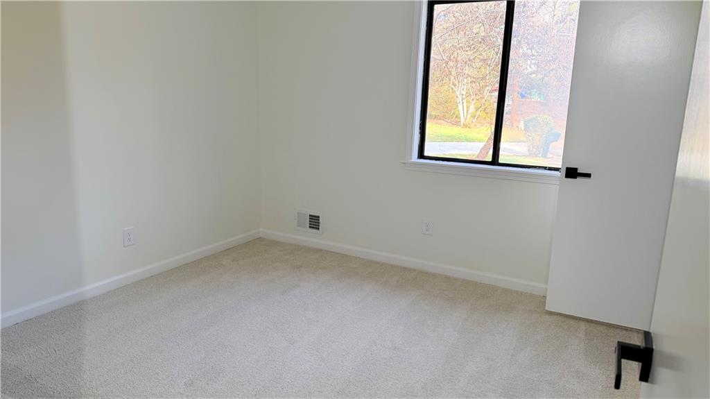 5257 Post Ridge Court Stone Mountain, GA 30088 - Photo 38 of 42 an empty room with a window