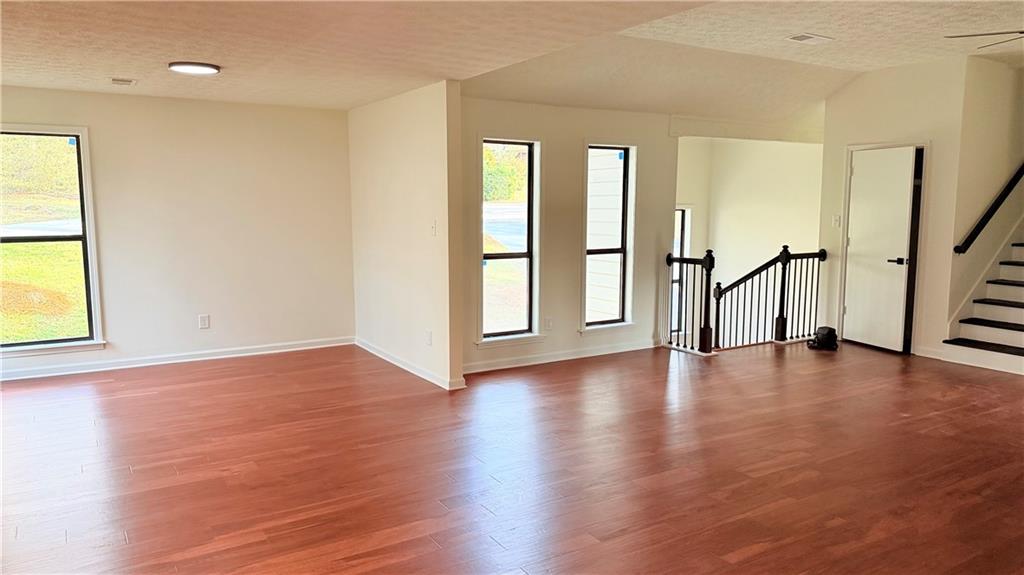 5257 Post Ridge Court Stone Mountain, GA 30088 - Photo 6 of 42 an empty room with wooden floor and windows