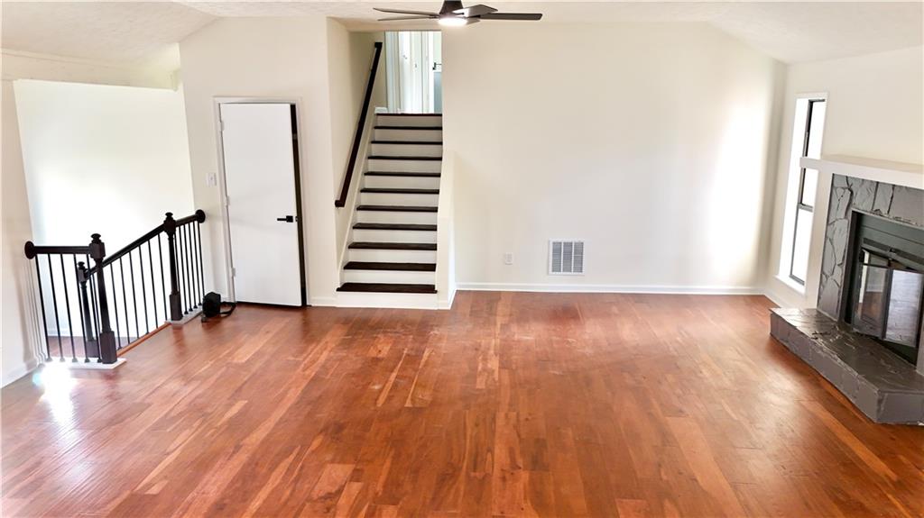 5257 Post Ridge Court Stone Mountain, GA 30088 - Photo 8 of 42 a view of an empty room with wooden floor and fireplace