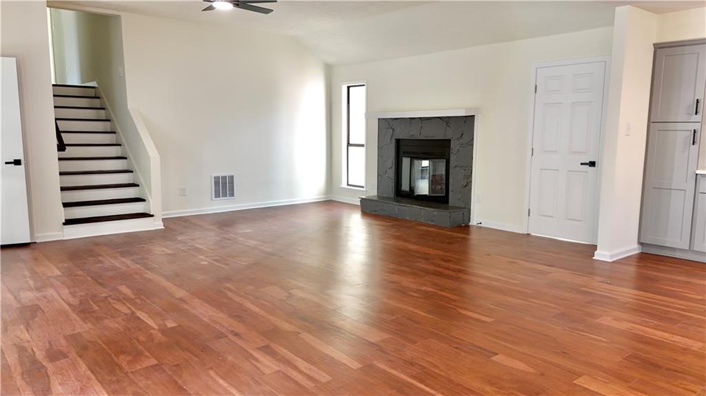 5257 Post Ridge Court Stone Mountain, GA 30088 - Photo 9 of 42 a view of a livingroom with wooden floor and fireplace