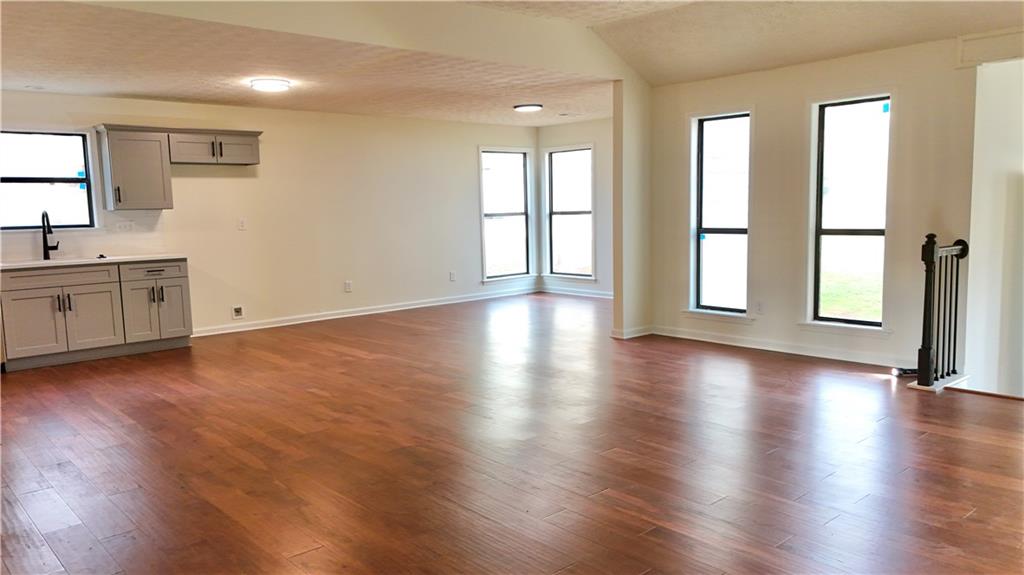 5257 Post Ridge Court Stone Mountain, GA 30088 - Photo 10 of 42 a view of an empty room with window and wooden floor