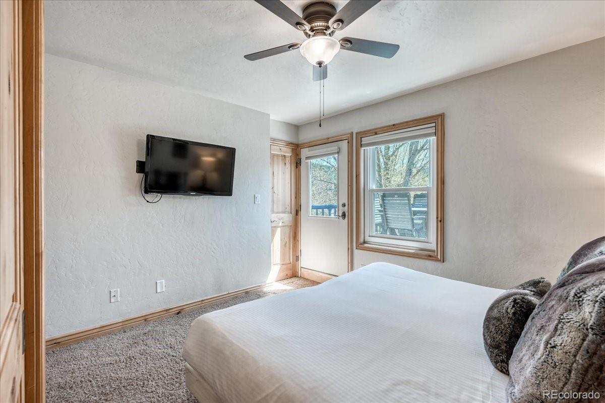 200 North Ridge Street, Unit R1 Breckenridge, CO 80424 - Photo 25 of 27 a bedroom with a large bed a flat screen tv and a window