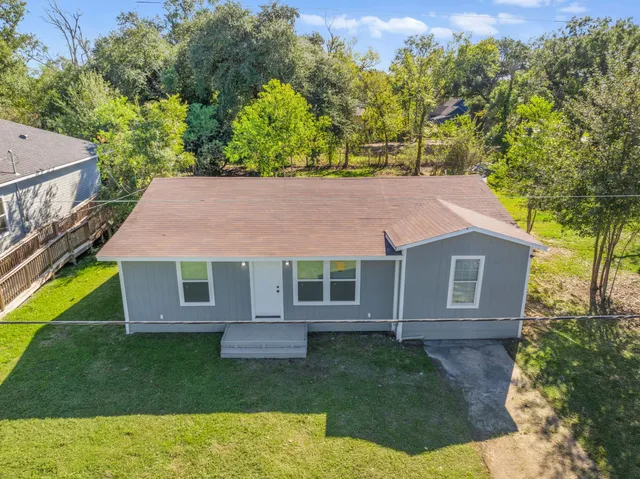 a aerial view of a house with a yard