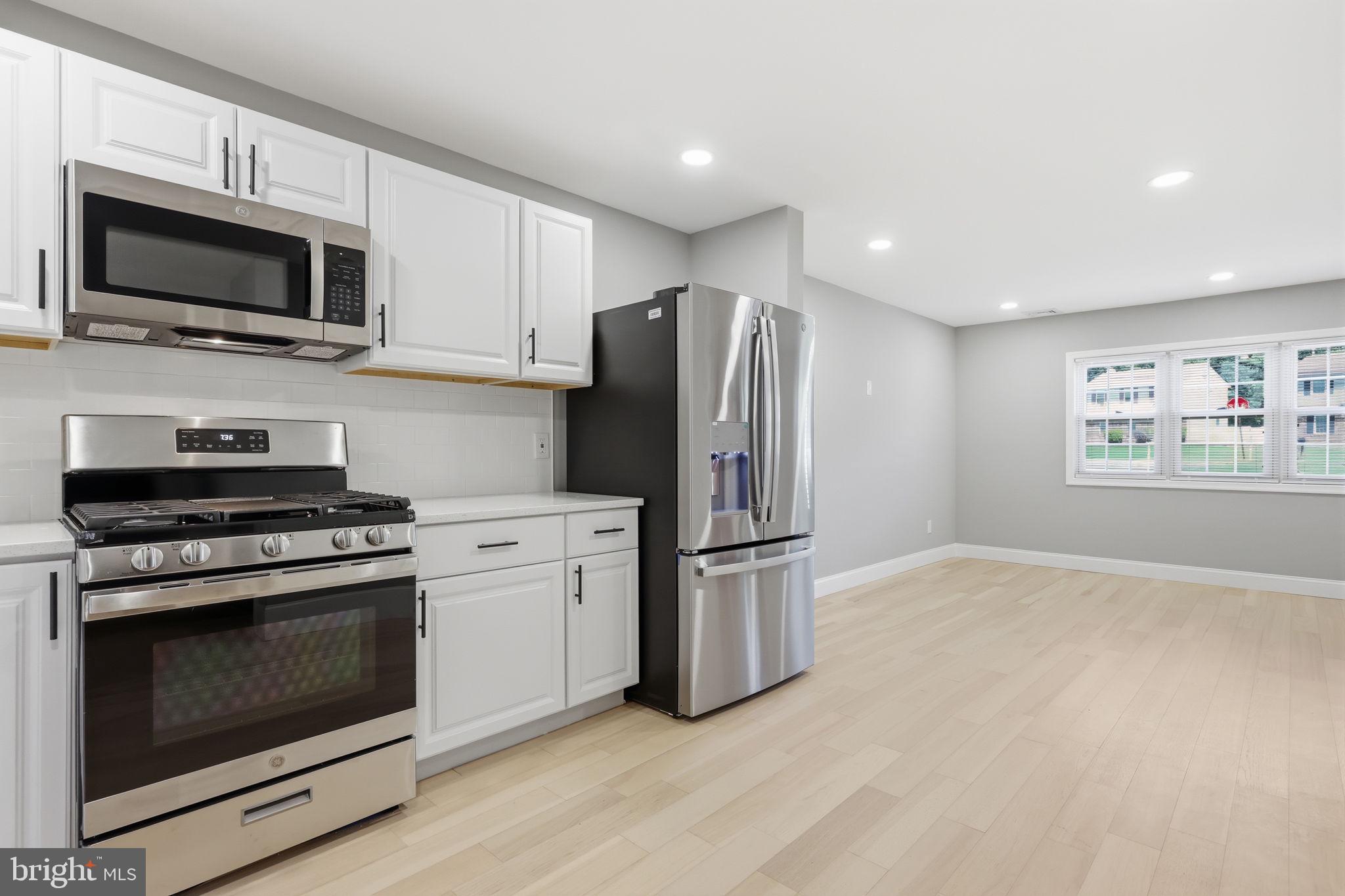 340 West Broad Street Hatfield, PA 19440 - Photo 14 of 55 a kitchen with stainless steel appliances a stove a microwave and white cabinets