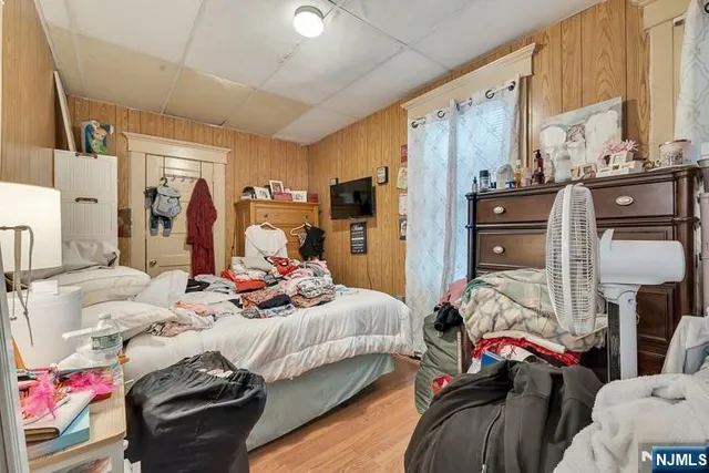 a bedroom with a bed and a tv