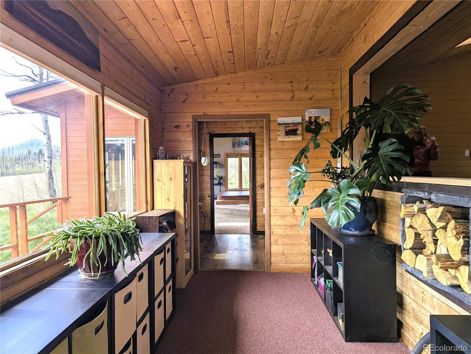2084 Forbes Park Road Fort Garland, CO 81133 - Photo 11 of 39 a hallway with with furniture and a potted plant