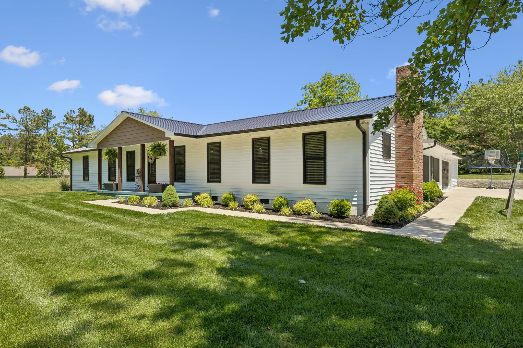109 Indian Creek Road Hohenwald, TN 38462 - Photo 1 of 69 a front view of a house with a yard