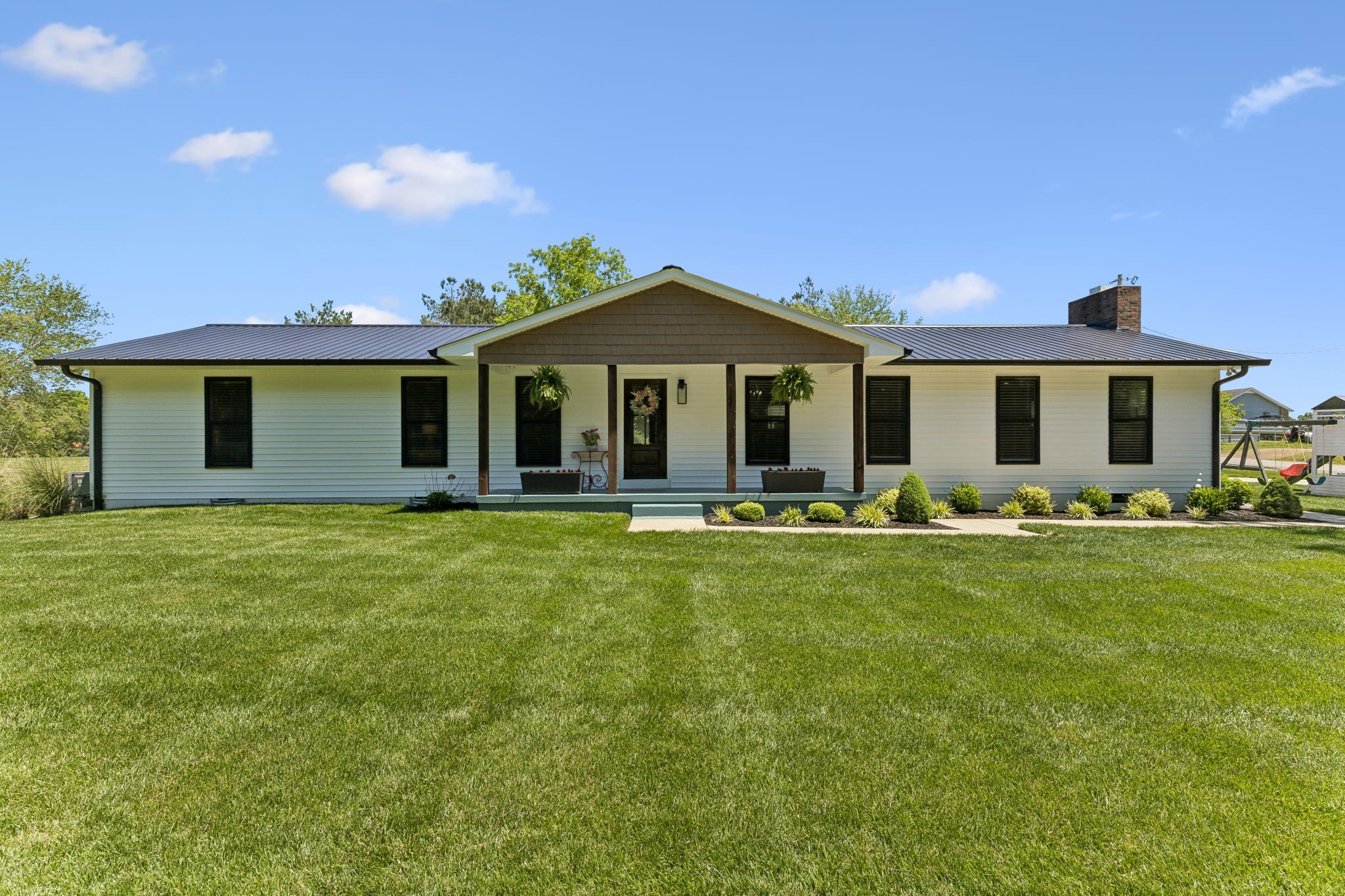 109 Indian Creek Road Hohenwald, TN 38462 - Photo 2 of 69 a front view of a house with a garden
