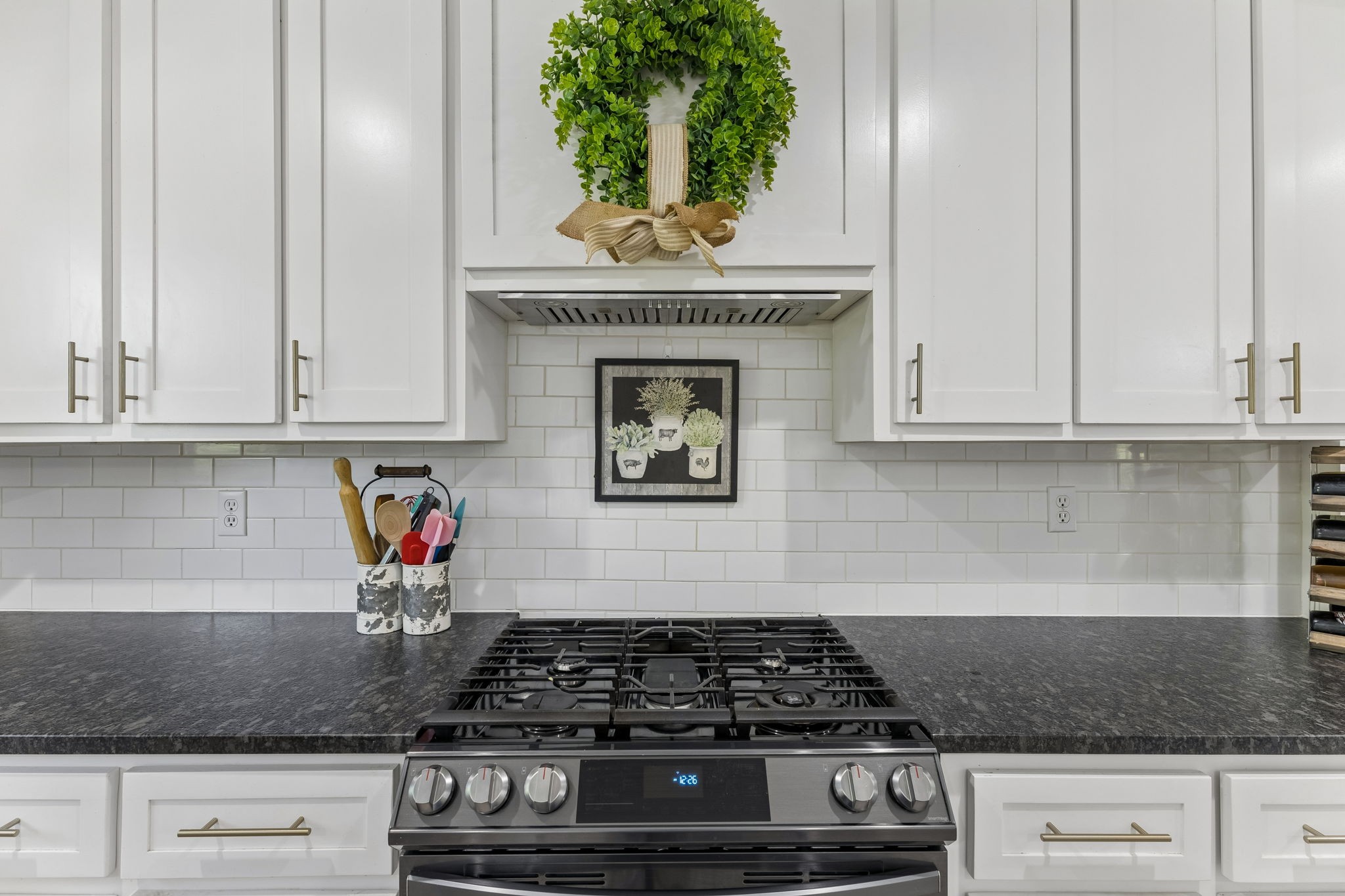 109 Indian Creek Road Hohenwald, TN 38462 - Photo 25 of 69 a kitchen with granite countertop white cabinets and stainless steel appliances