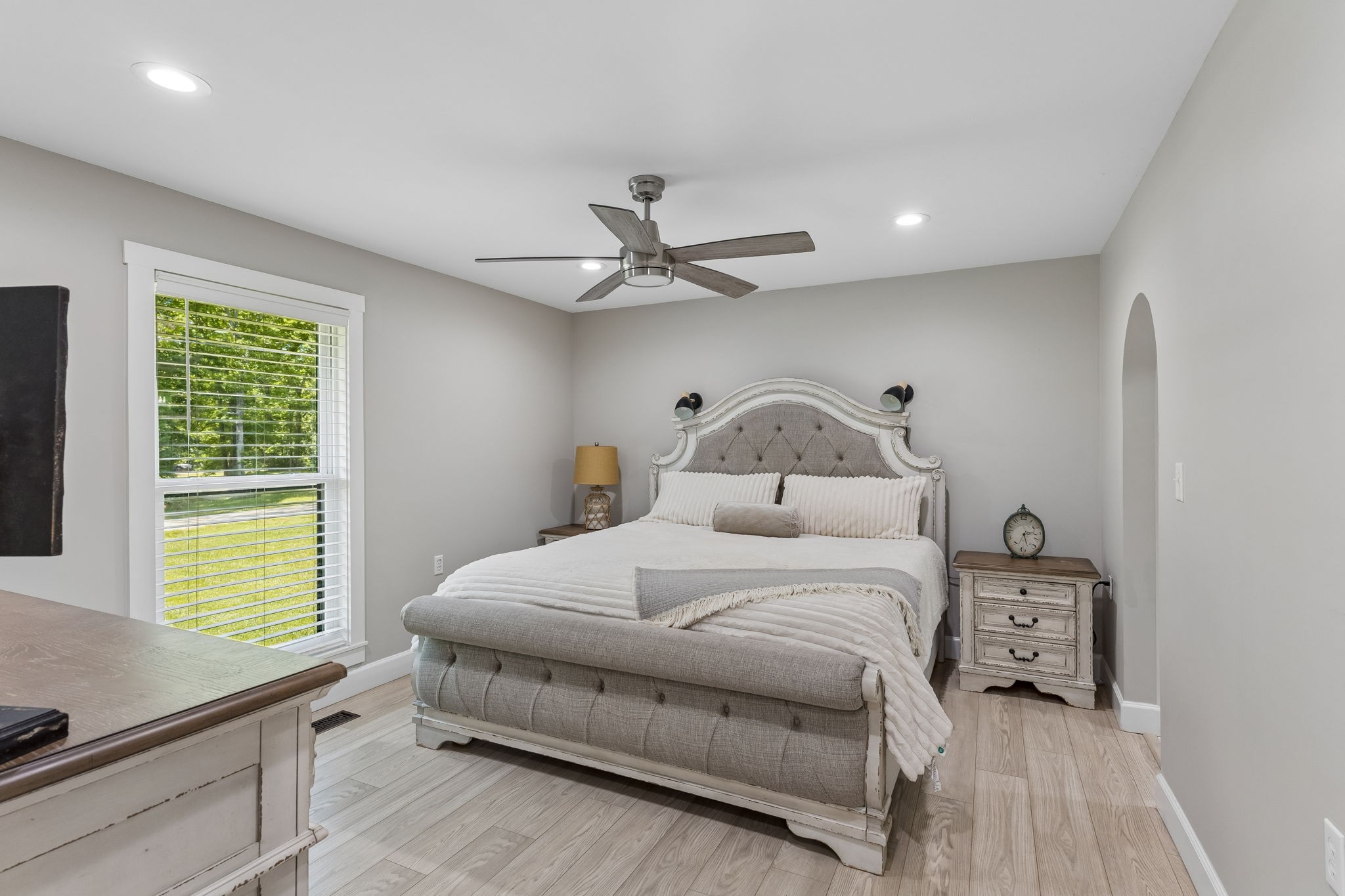 109 Indian Creek Road Hohenwald, TN 38462 - Photo 27 of 69 a bedroom with a bed and a ceiling fan