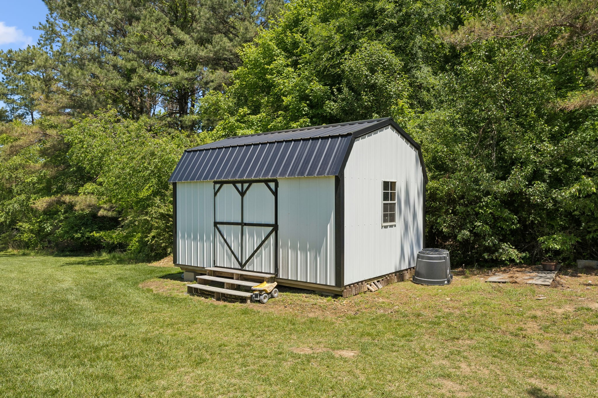 109 Indian Creek Road Hohenwald, TN 38462 - Photo 48 of 69 a view of a small house with a yard and large tree