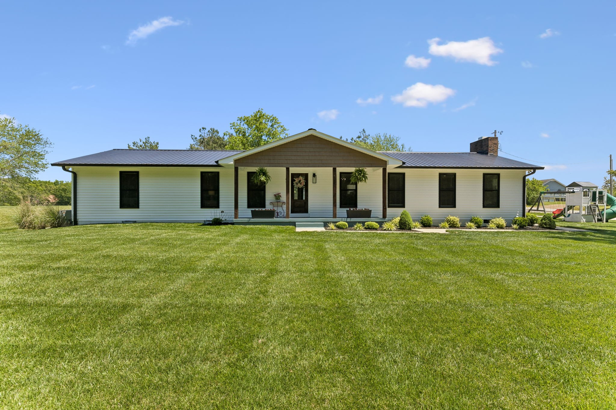 109 Indian Creek Road Hohenwald, TN 38462 - Photo 6 of 69 a front view of a house with a garden