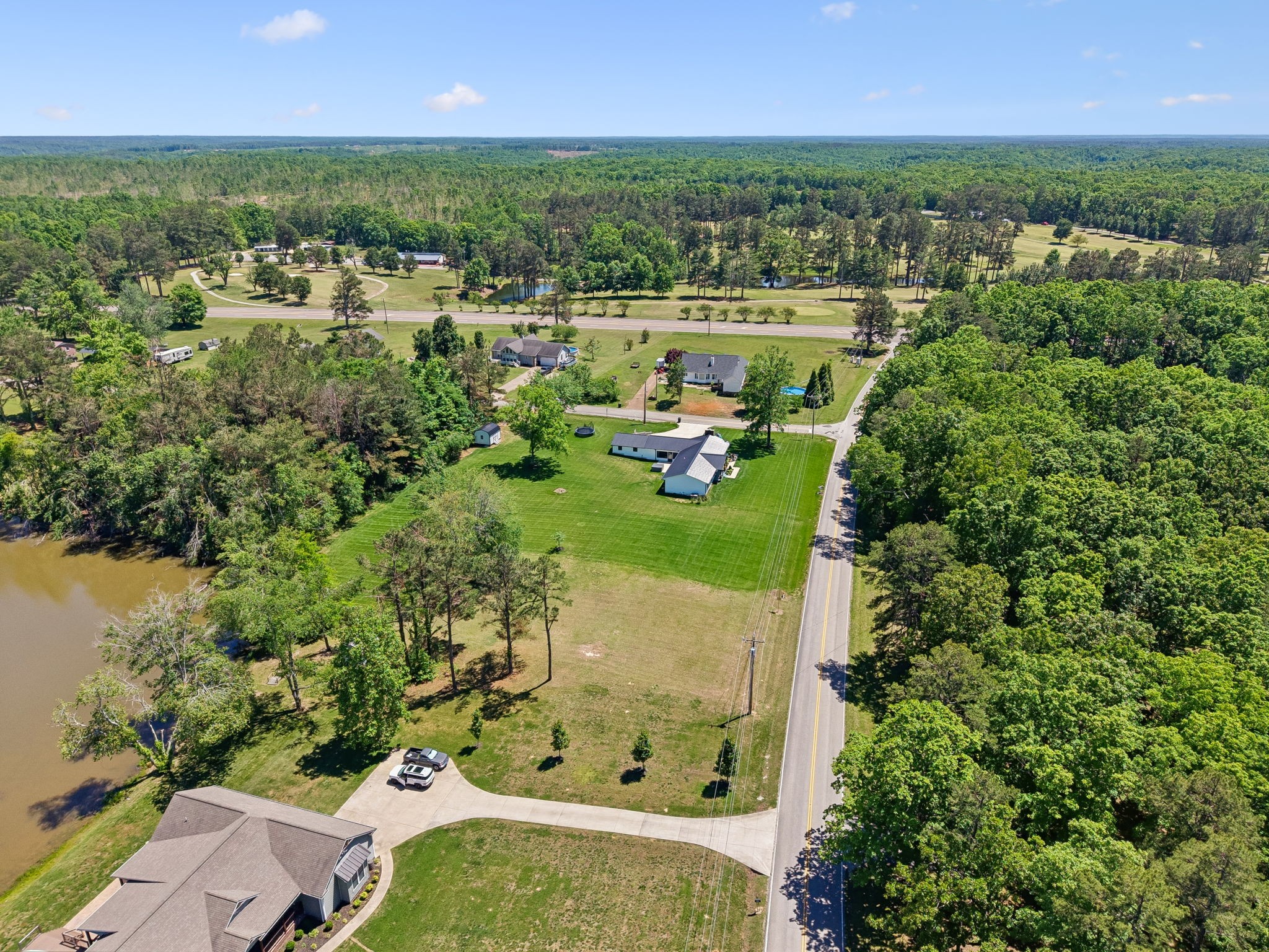 109 Indian Creek Road Hohenwald, TN 38462 - Photo 66 of 69 an aerial view of residential houses with outdoor space and lake view