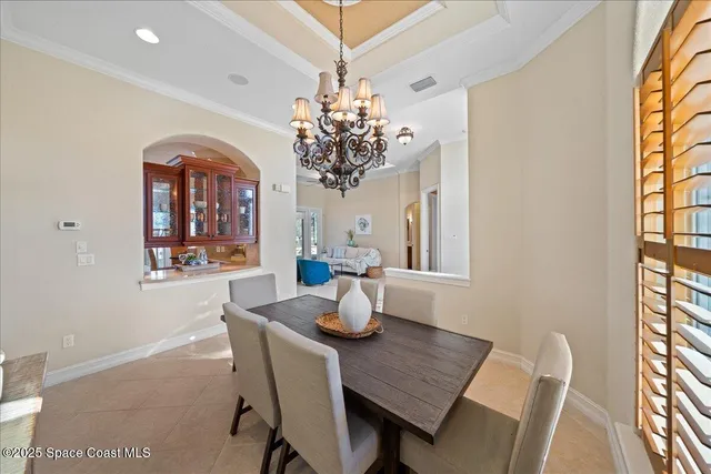 a roof deck with table and chairs under an umbrella
