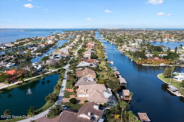 a view of a dining room with furniture and a chandelier