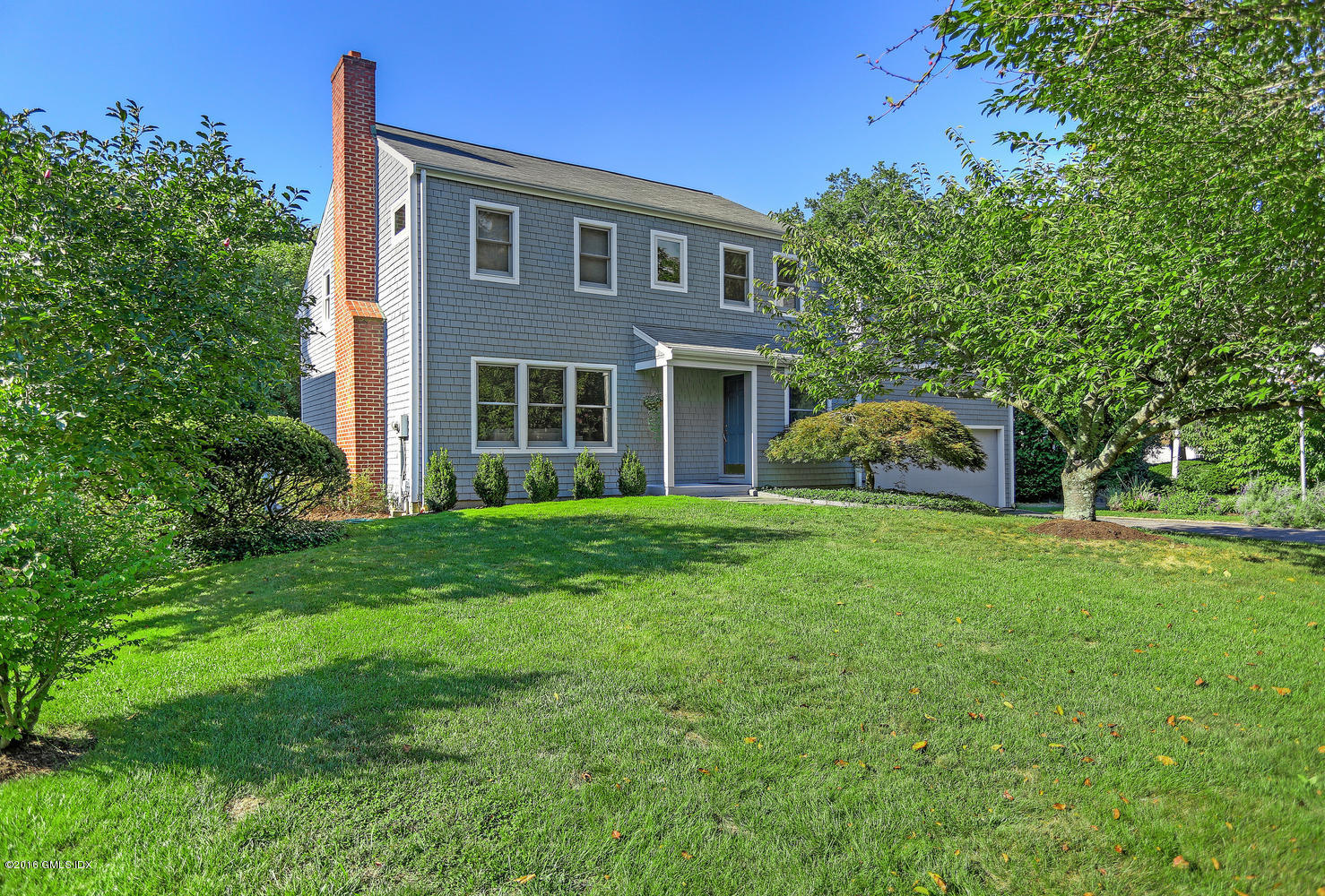12 Lake Drive, Unit SOUTH Riverside, CT 06878 - Photo 1 of 21 a front view of a house with garden and trees