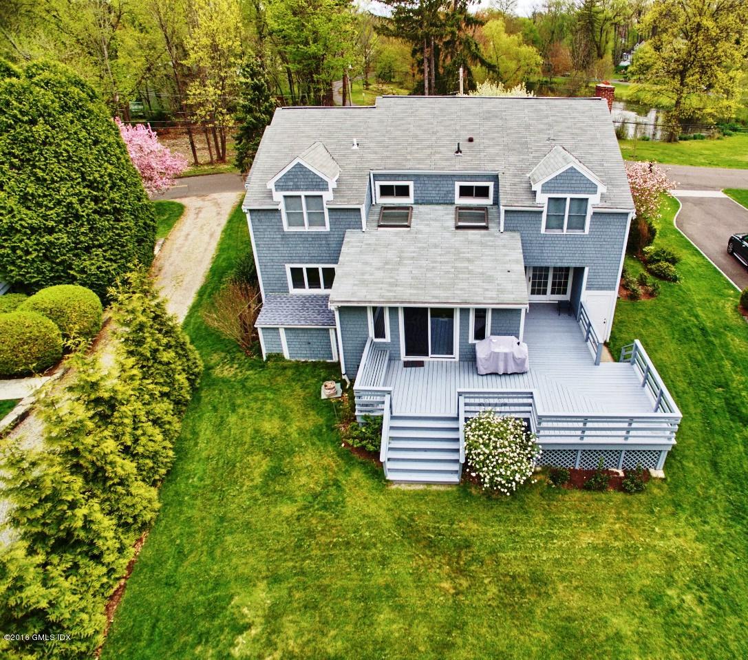12 Lake Drive, Unit SOUTH Riverside, CT 06878 - Photo 15 of 21 a aerial view of a house with swimming pool next to a yard