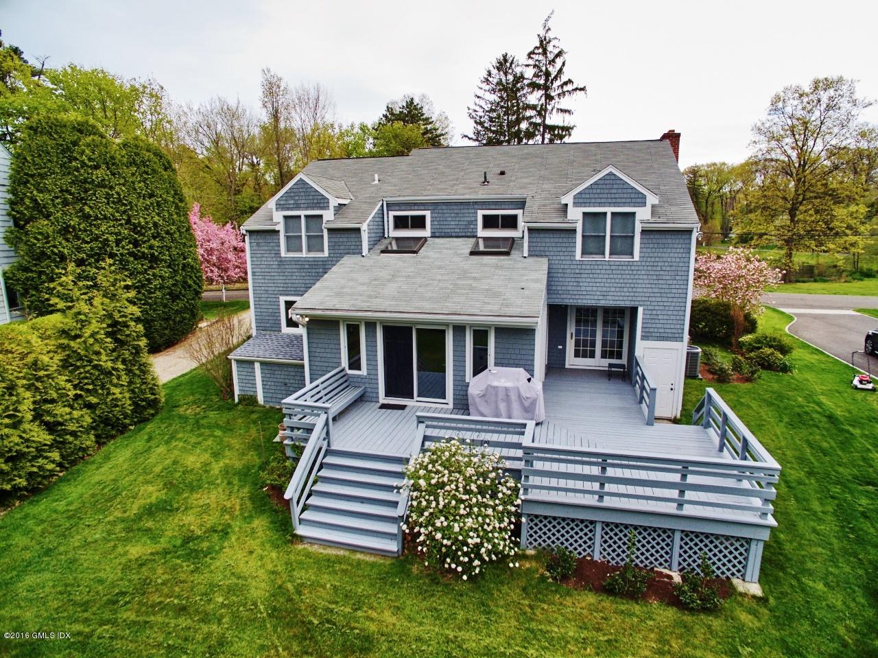 12 Lake Drive, Unit SOUTH Riverside, CT 06878 - Photo 16 of 21 a front view of a house with a garden