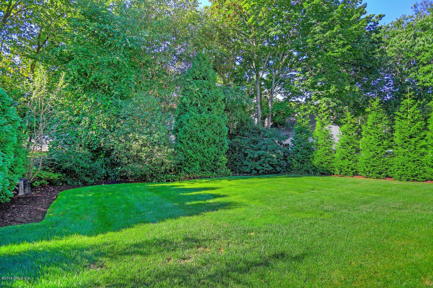 12 Lake Drive, Unit SOUTH Riverside, CT 06878 - Photo 17 of 21 a view of a grassy field with trees in the background