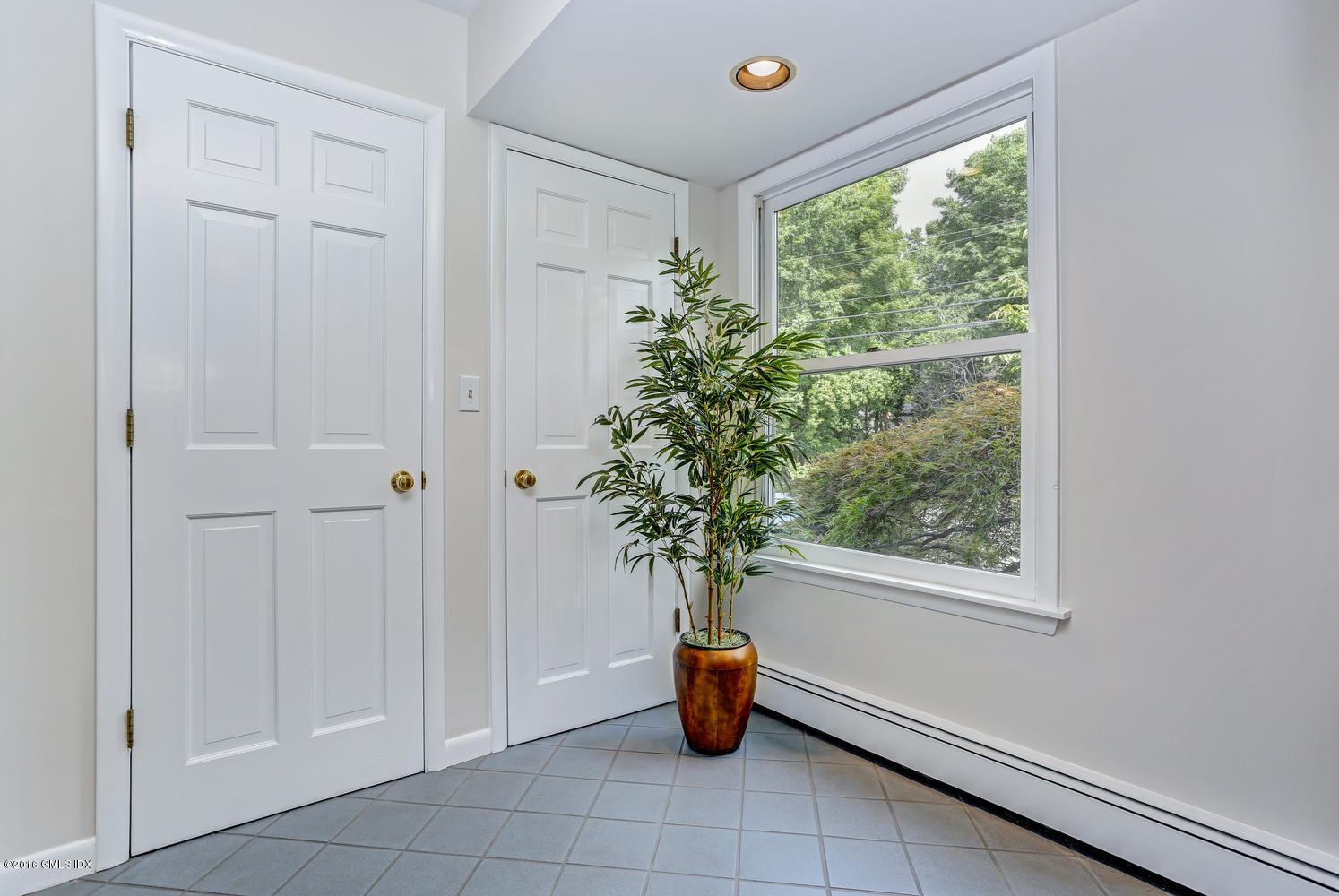 12 Lake Drive, Unit SOUTH Riverside, CT 06878 - Photo 2 of 21 a vase of flowers sitting on a window