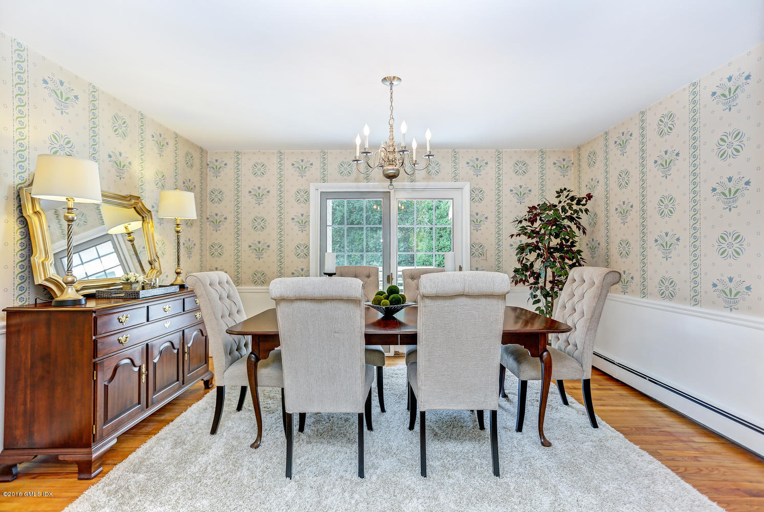 12 Lake Drive, Unit SOUTH Riverside, CT 06878 - Photo 4 of 21 a dining room with furniture a chandelier and wooden floor