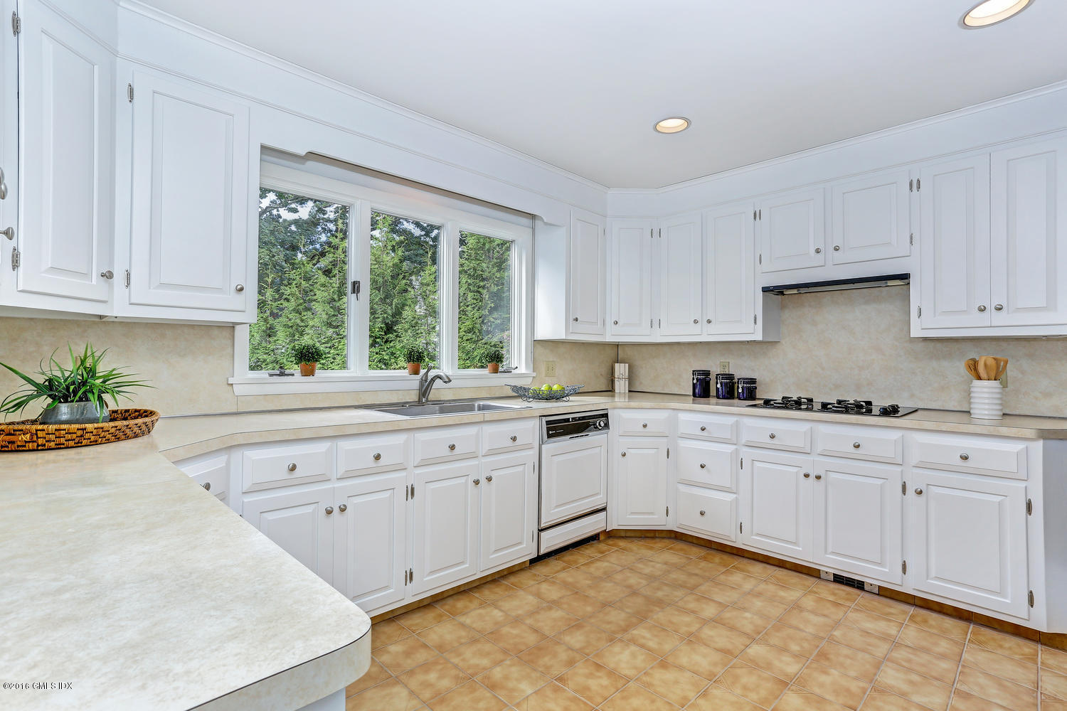 12 Lake Drive, Unit SOUTH Riverside, CT 06878 - Photo 7 of 21 a kitchen with granite countertop white cabinets and window