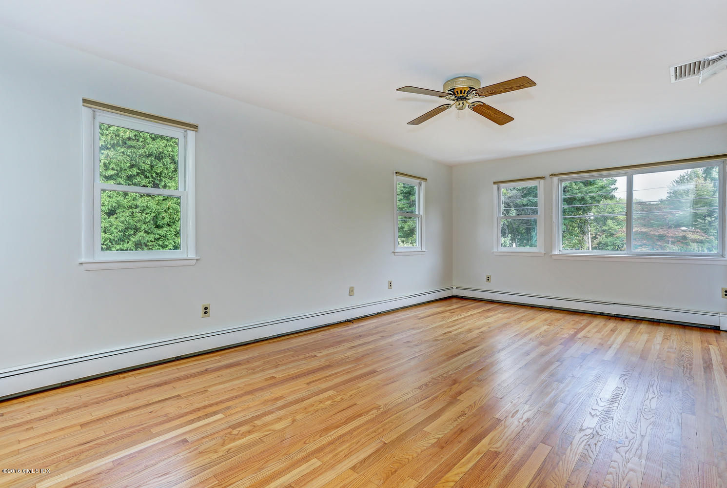 12 Lake Drive, Unit SOUTH Riverside, CT 06878 - Photo 9 of 21 a view of empty room with wooden floor and fan