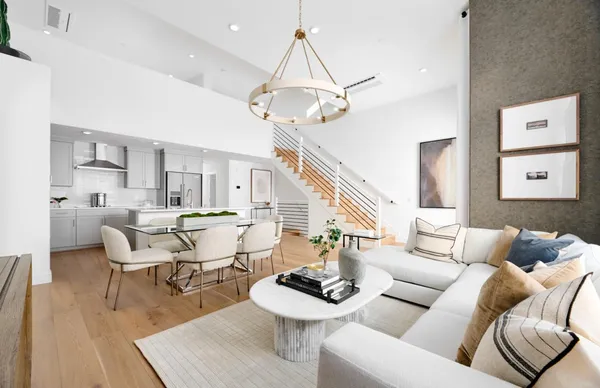 a living room with furniture a rug and a chandelier