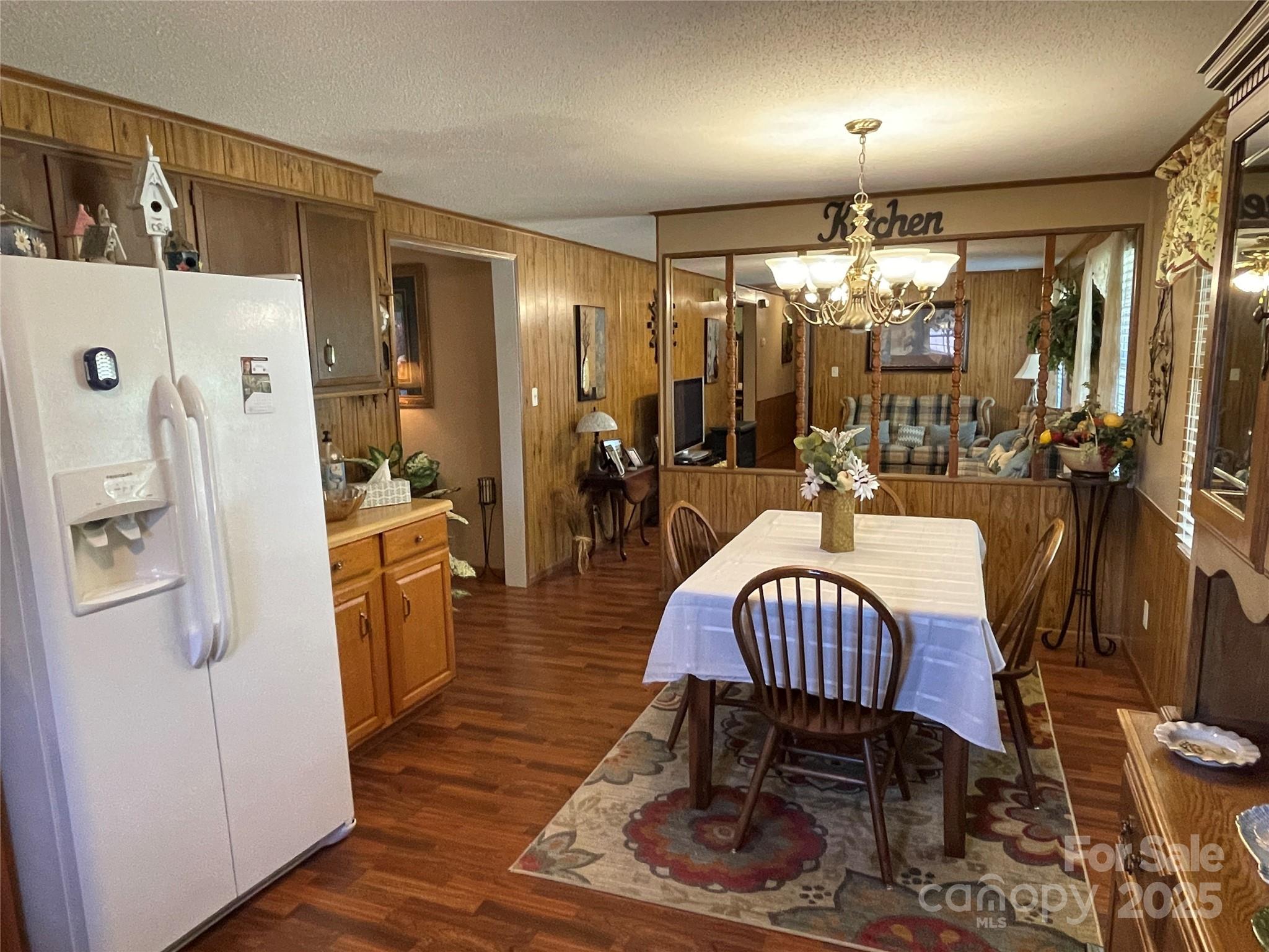 3403 Beaty Road Gastonia, NC 28056 - Photo 15 of 40 a dining room with furniture a chandelier and wooden floor