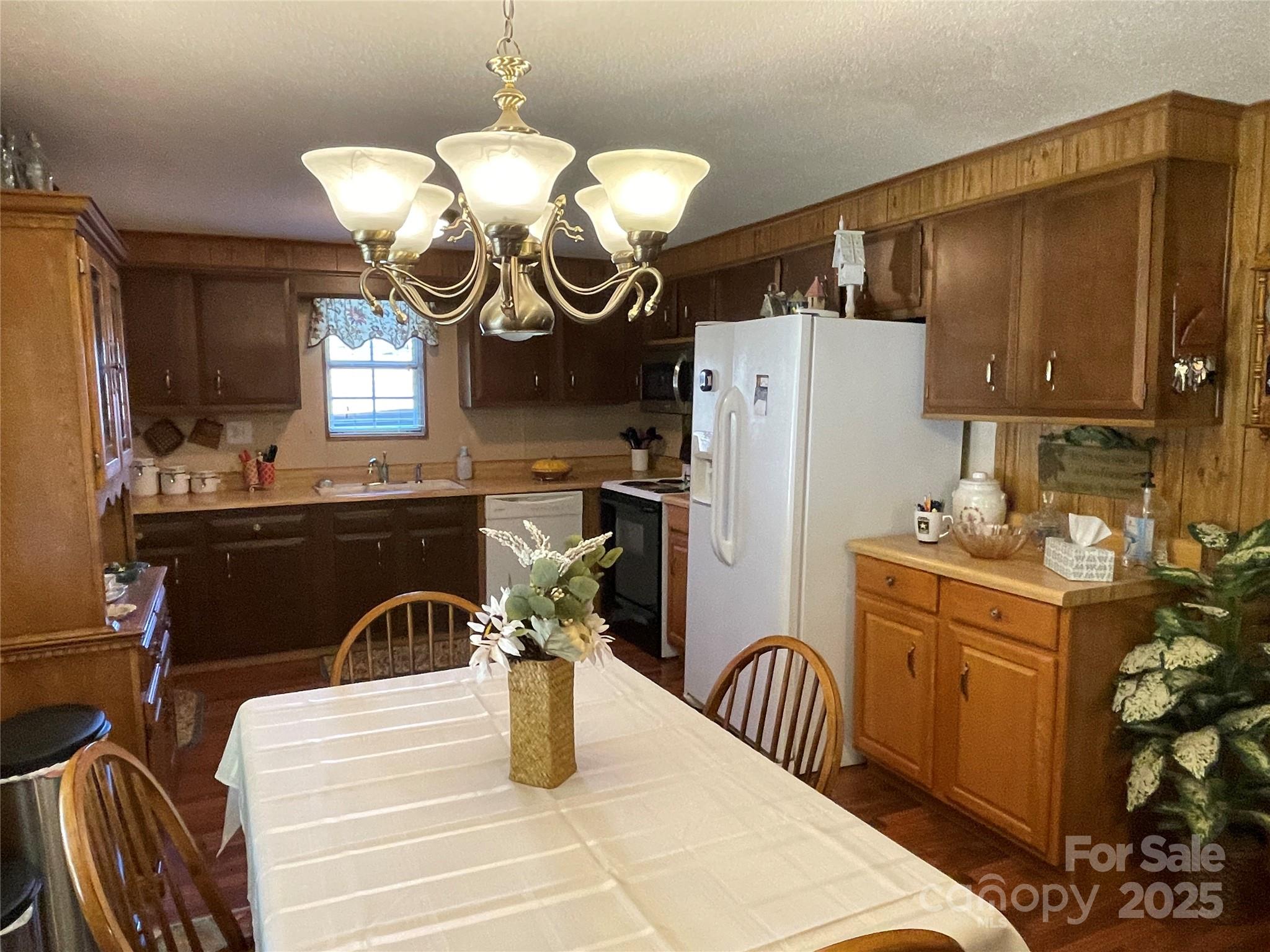3403 Beaty Road Gastonia, NC 28056 - Photo 17 of 40 a kitchen with a refrigerator a sink and cabinets